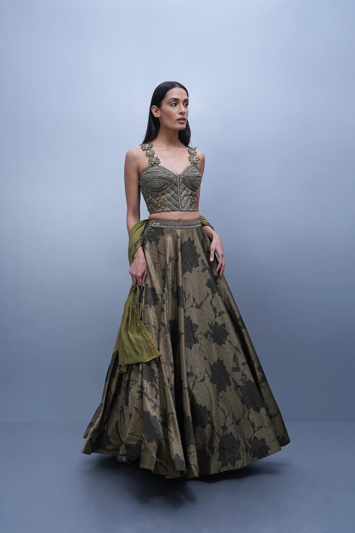 Dark olive green printed lehenga with a corset style blouse
