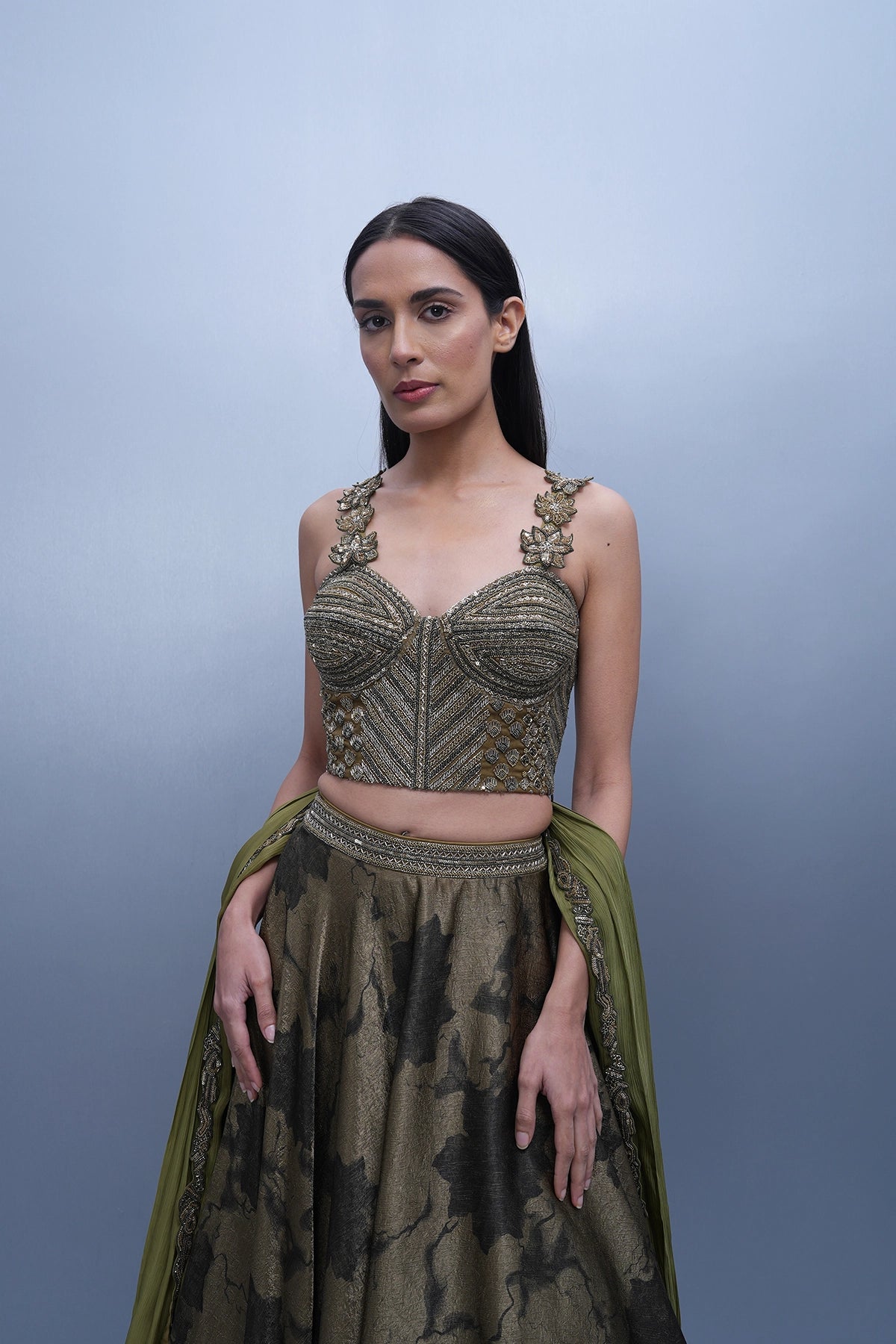 Dark olive green printed lehenga with a corset style blouse