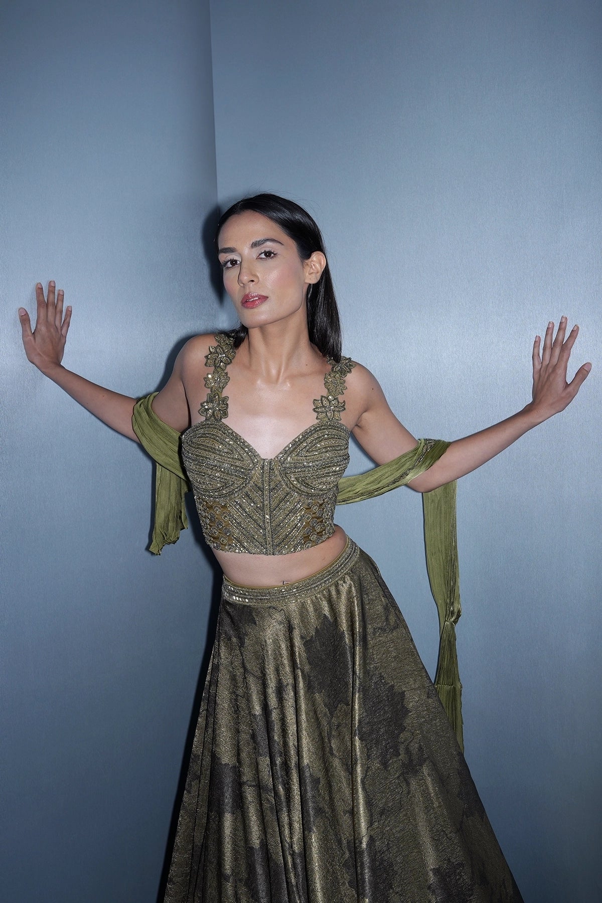 Dark olive green printed lehenga with a corset style blouse