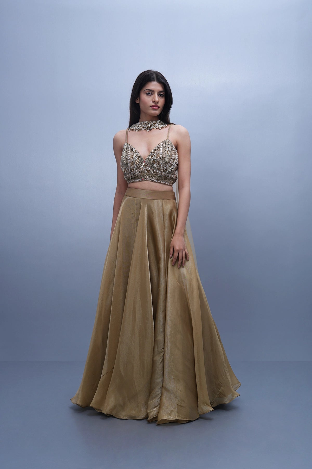 Gold lehenga in tissue with spaghetti blouse and choker dupatta