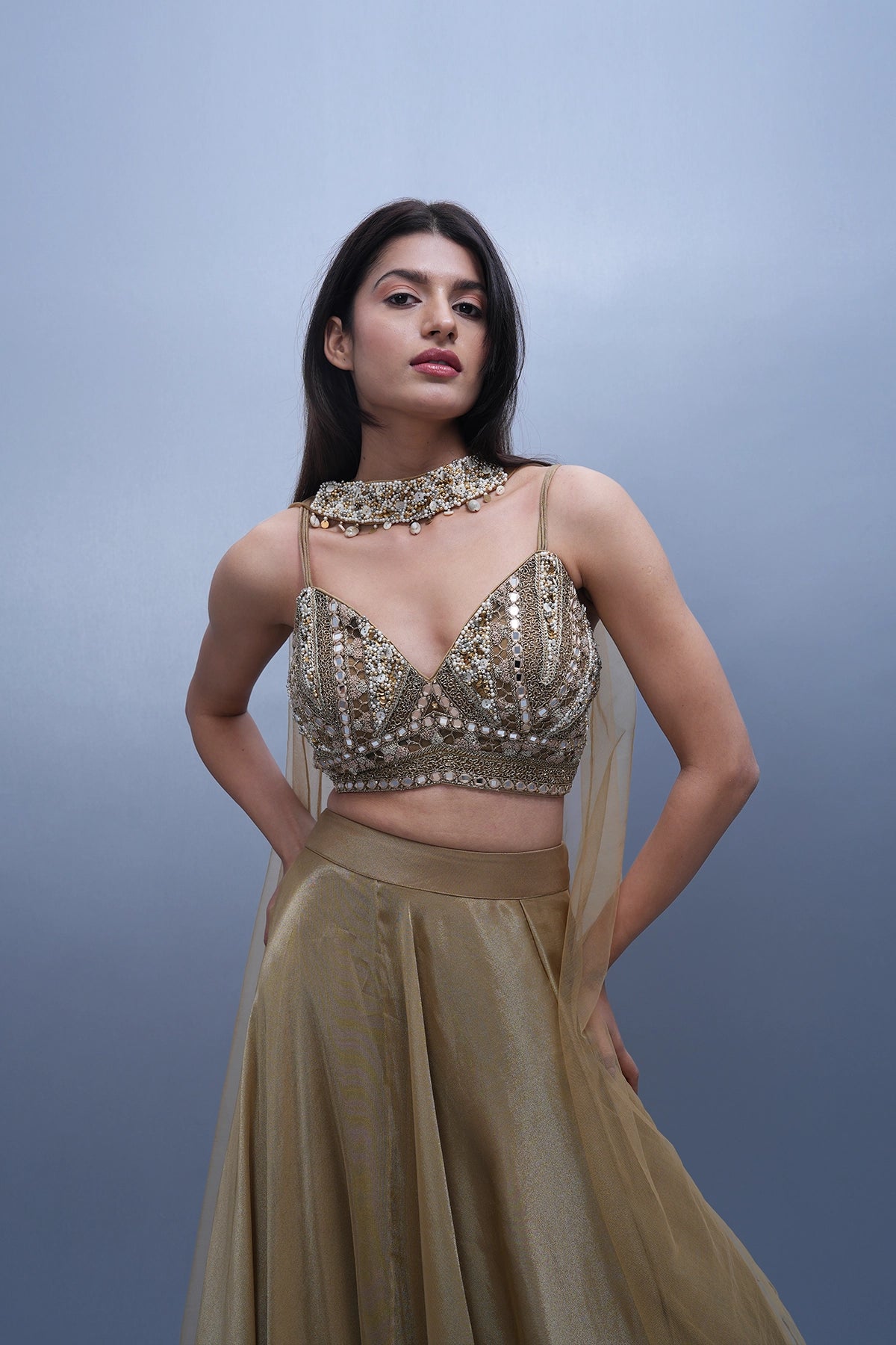 Gold lehenga in tissue with spaghetti blouse and choker dupatta