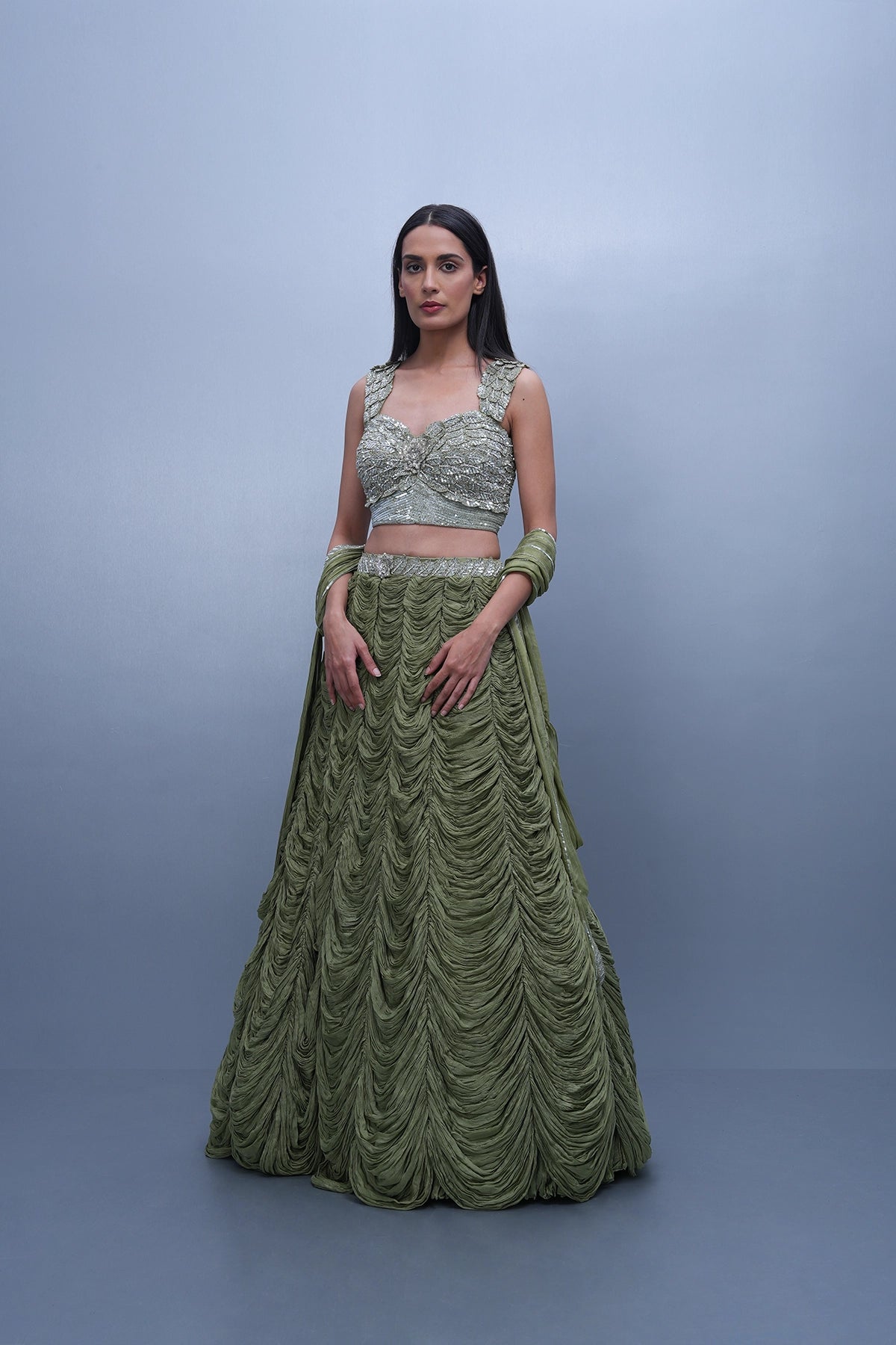 Sage green lehenga with an embellished blouse and an attached drape