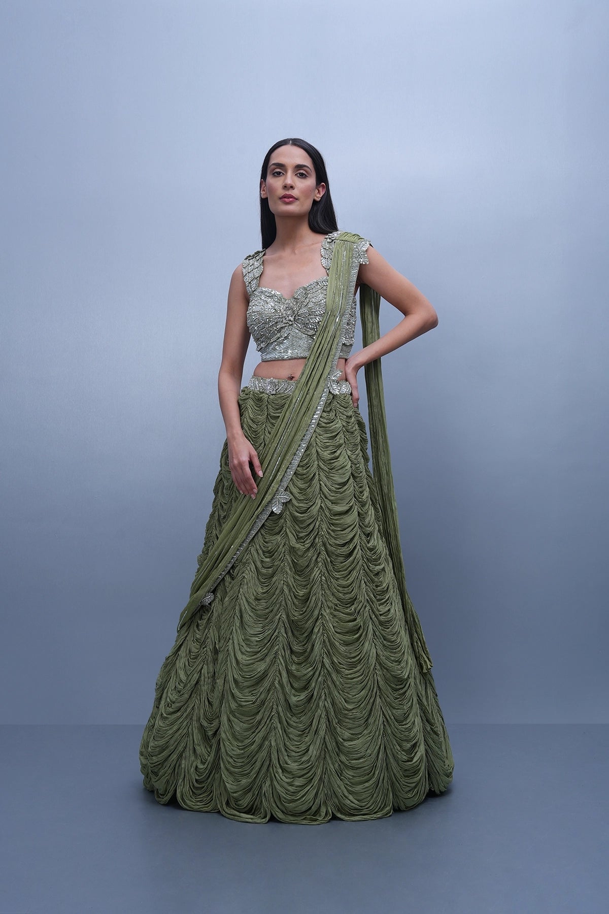 Sage green lehenga with an embellished blouse and an attached drape