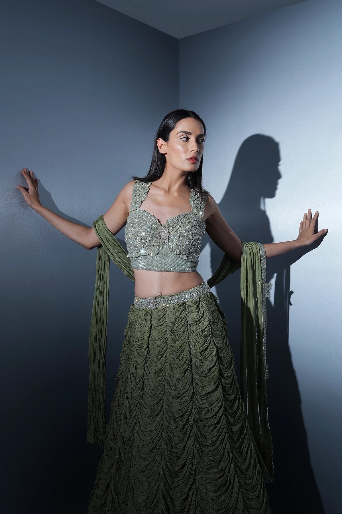Sage green lehenga with an embellished blouse and an attached drape