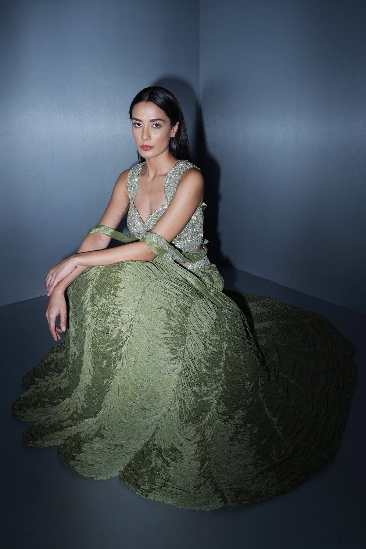 Sage green lehenga with an embellished blouse and an attached drape