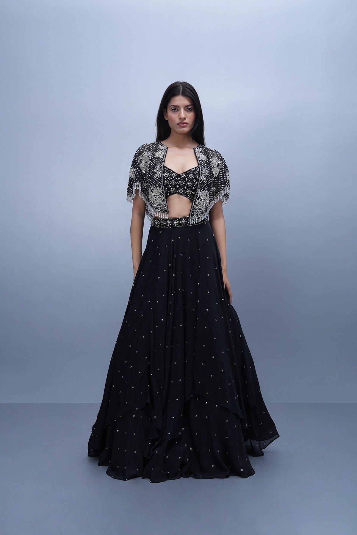 Black lehenga set in chinnon with spaghettic blouse and cape
