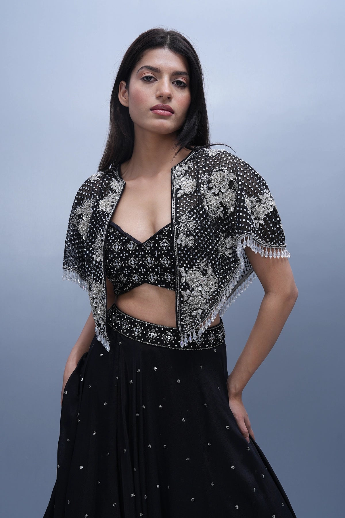 Black lehenga set in chinnon with spaghettic blouse and cape