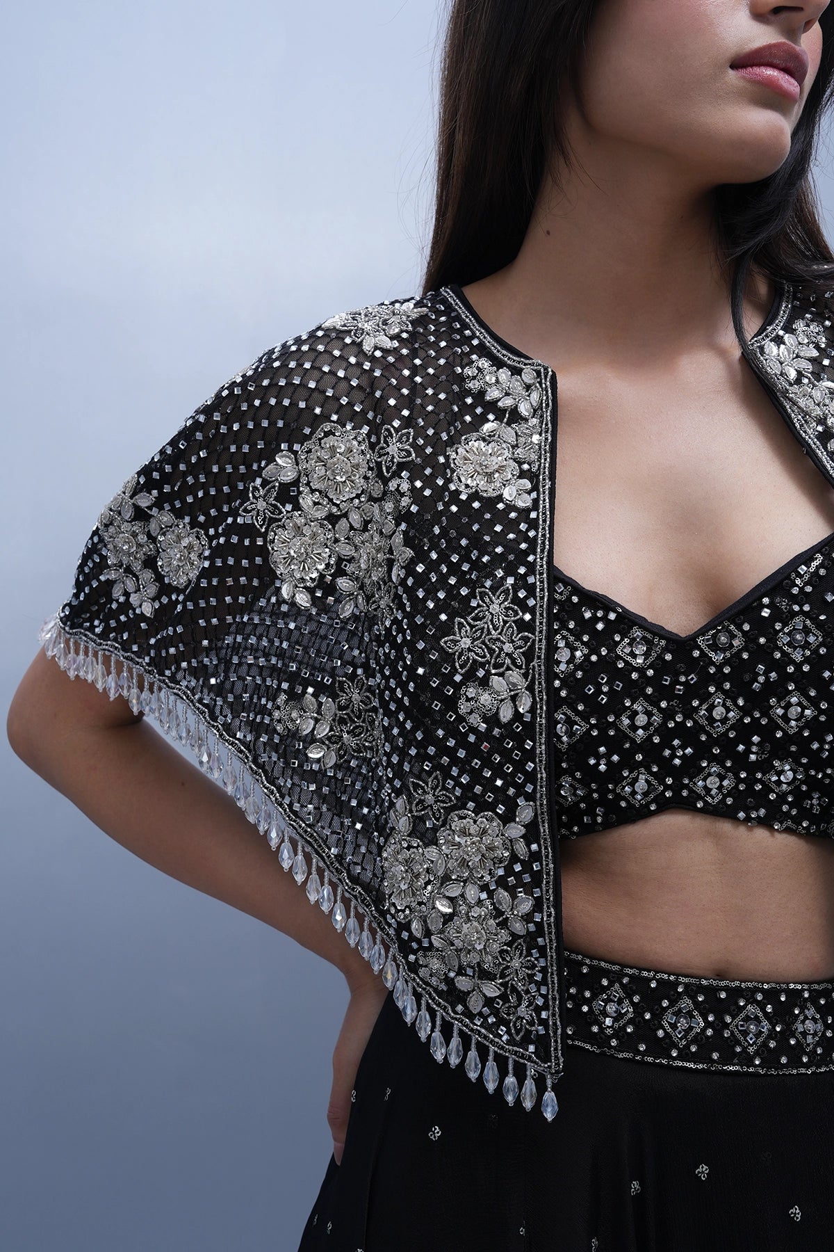 Black lehenga set in chinnon with spaghettic blouse and cape