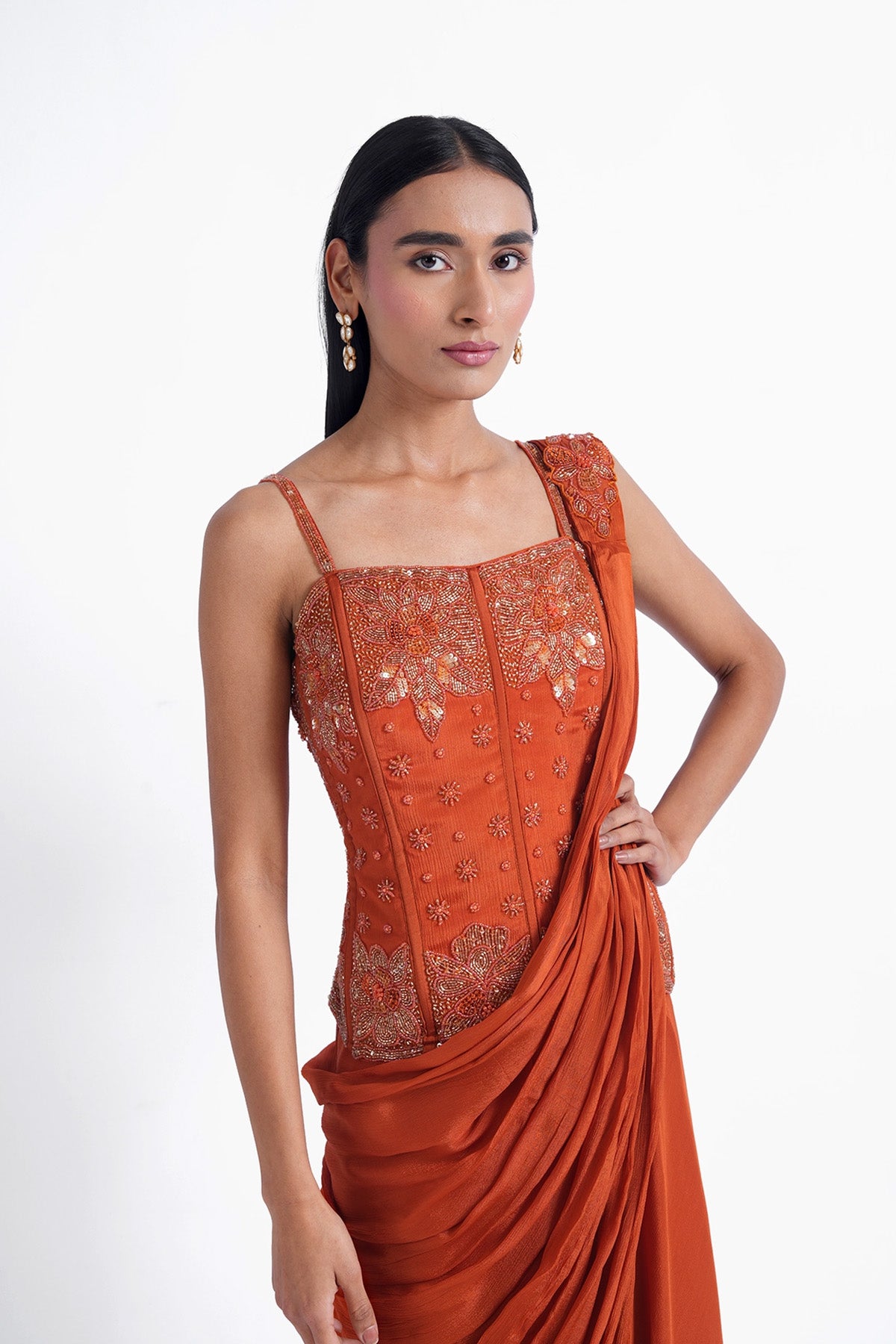 Rust orange palazzo saree paired with a long corset top