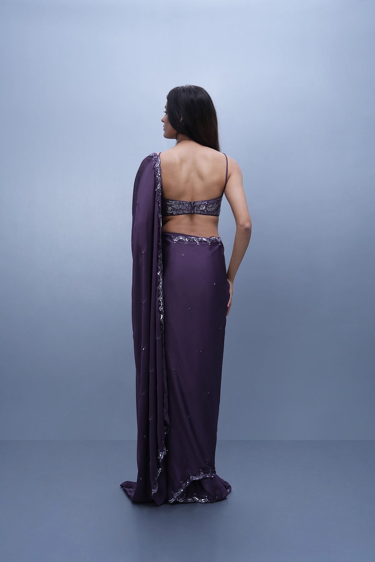 Violet satin saree with a spaghetti blouse