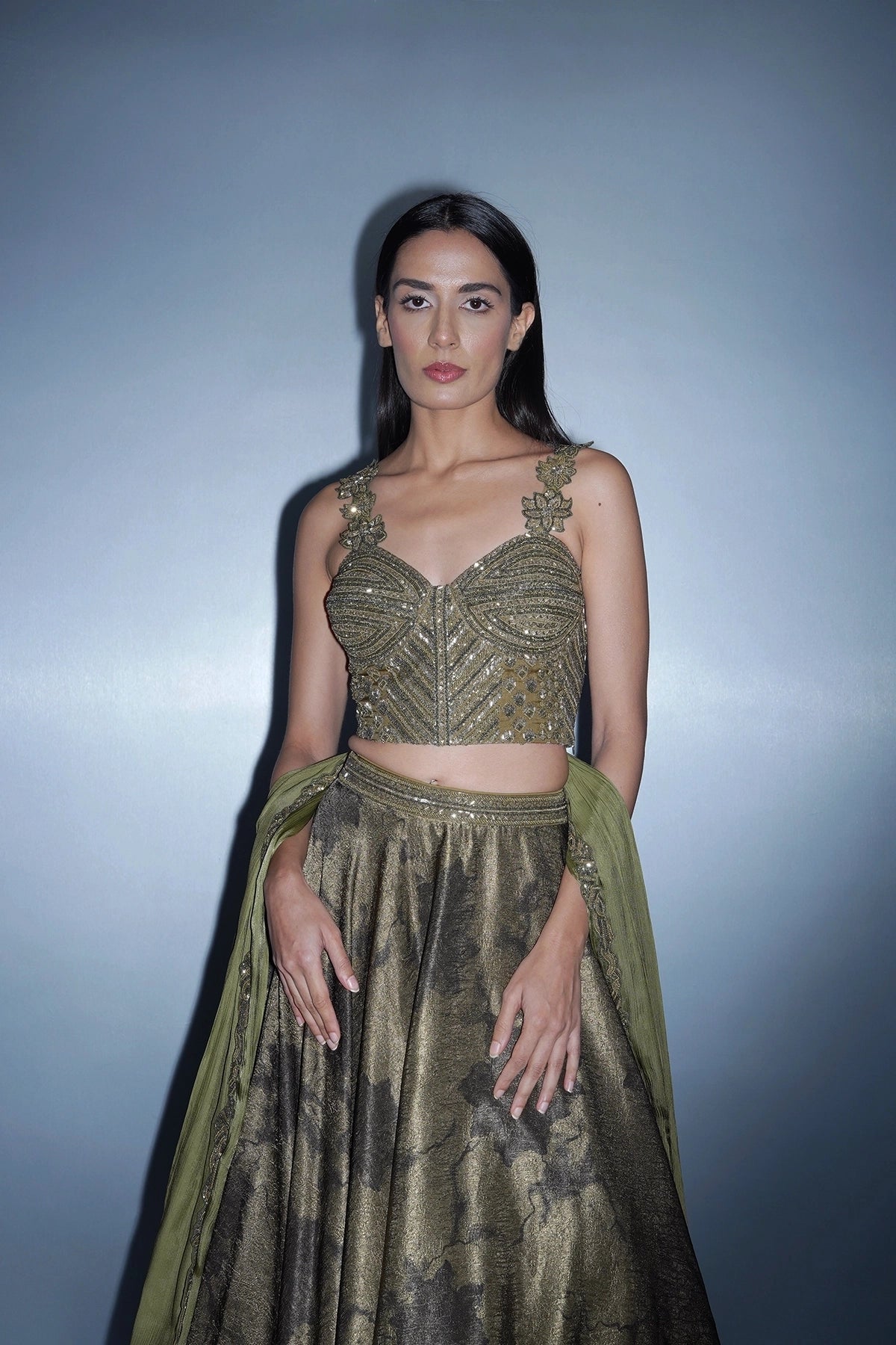 Dark olive green printed lehenga with a corset style blouse