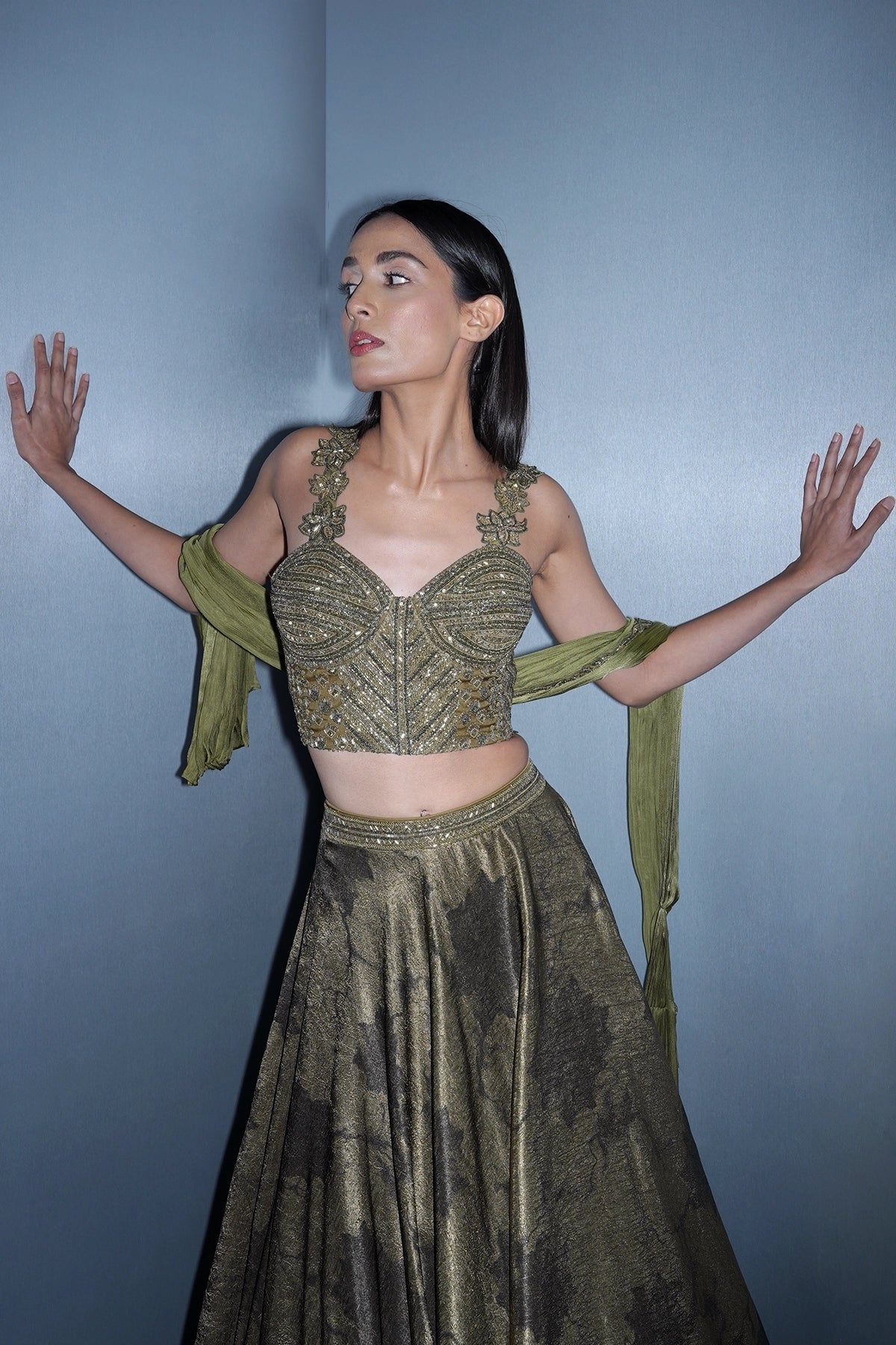 Dark olive green printed lehenga with a corset style blouse