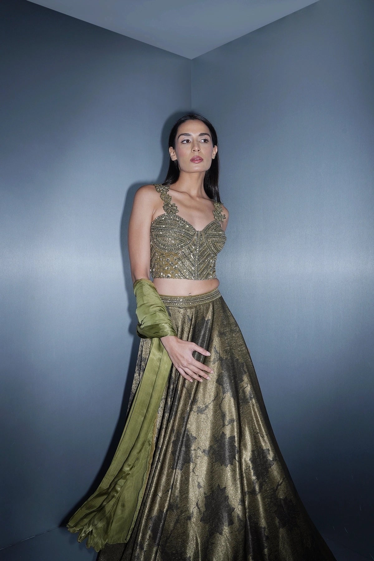 Dark olive green printed lehenga with a corset style blouse