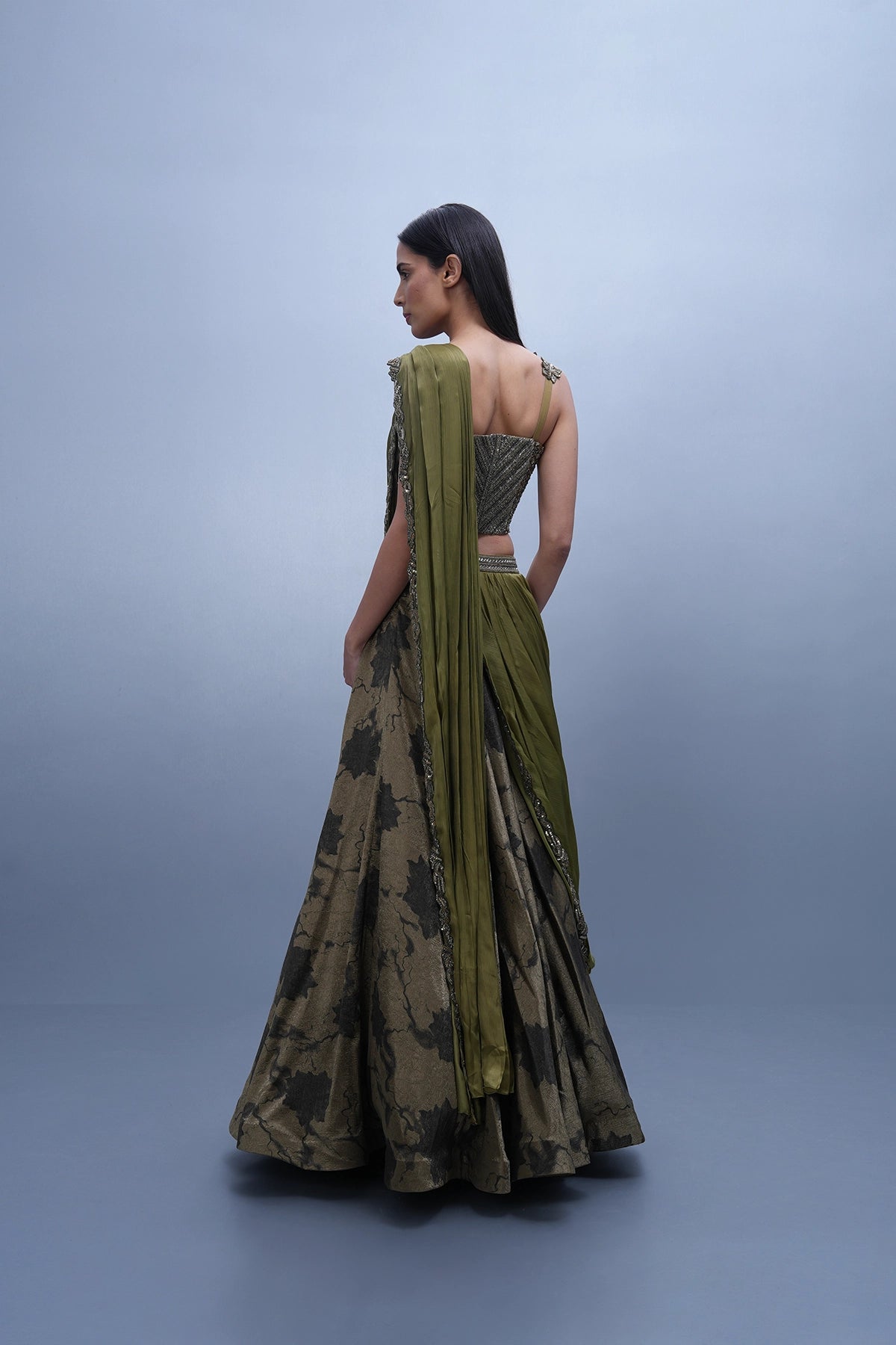 Dark olive green printed lehenga with a corset style blouse