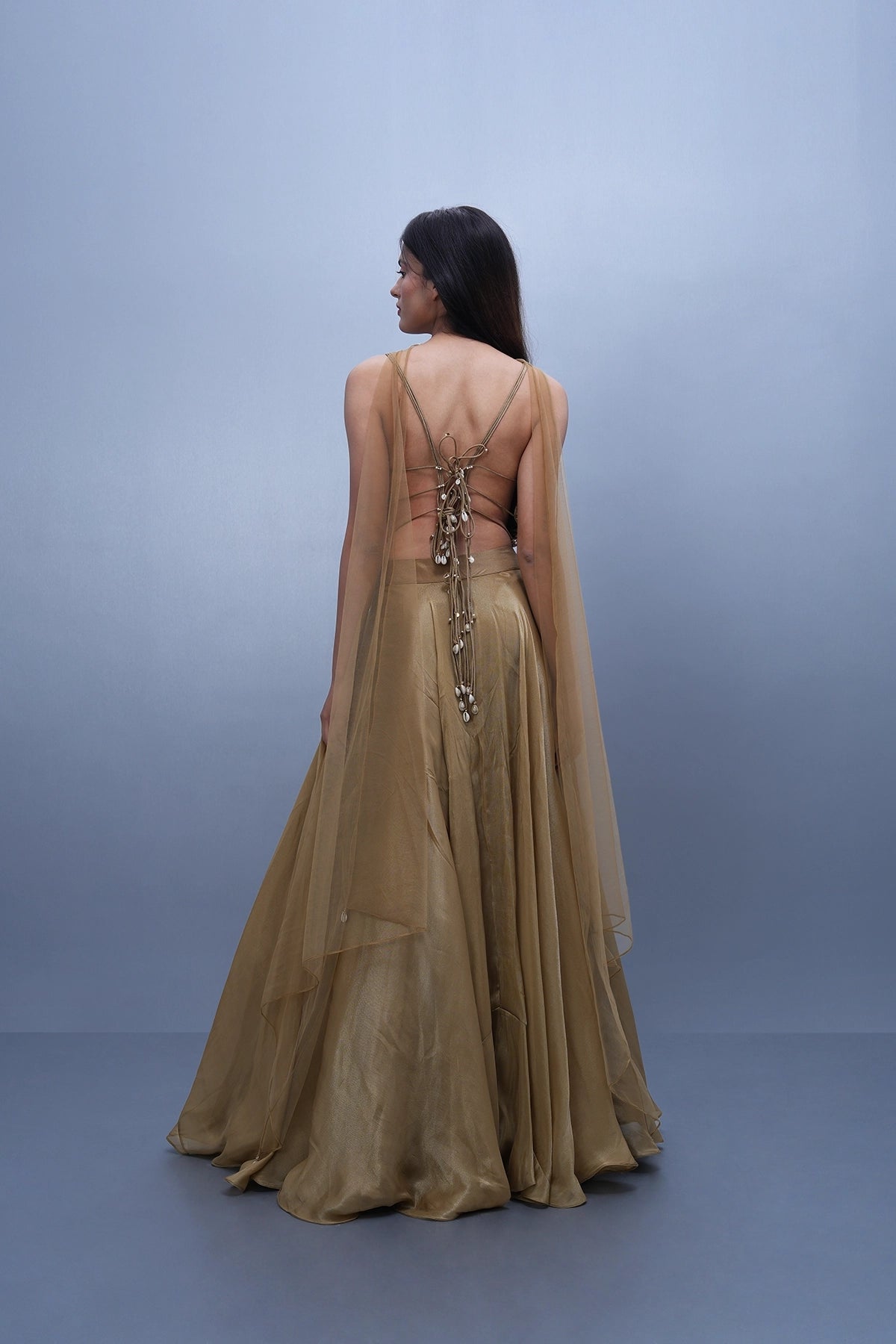 Gold lehenga in tissue with spaghetti blouse and choker dupatta