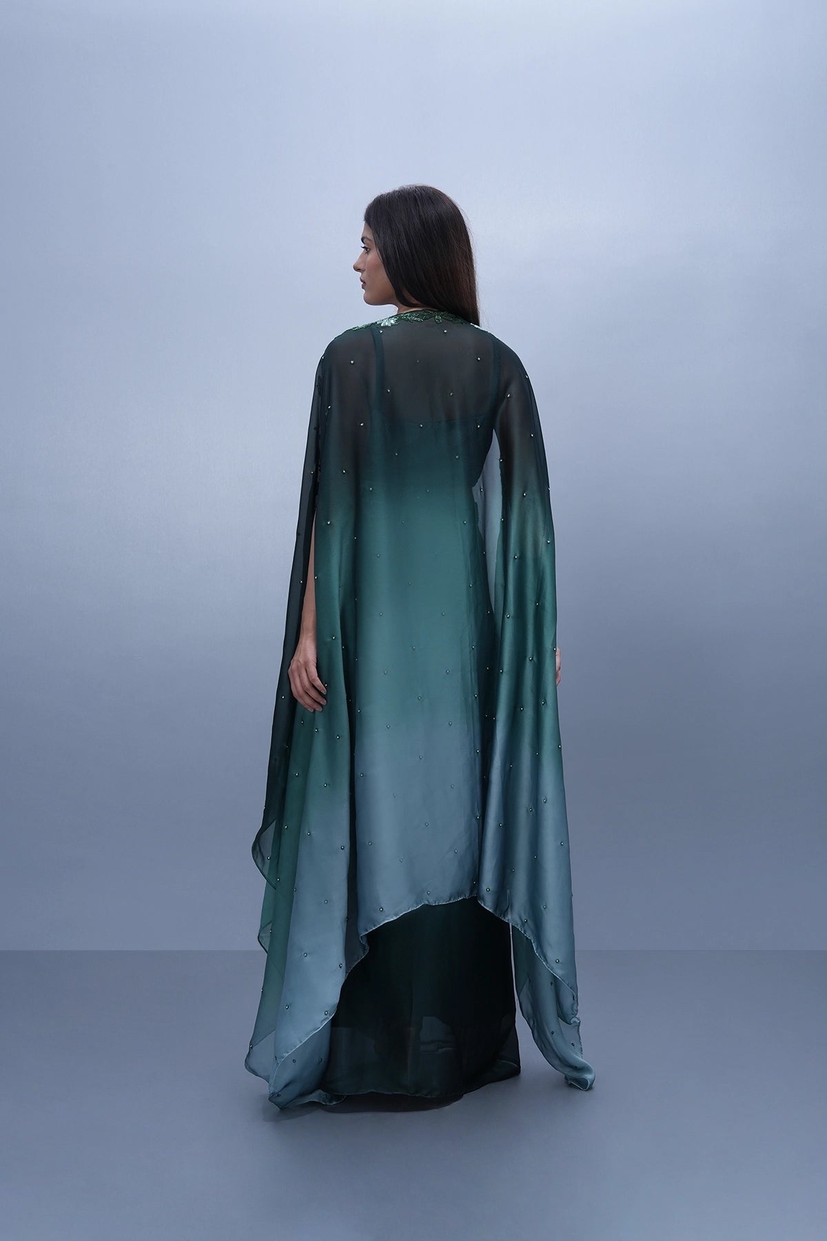 Bottle green shaded draped skirt set with hand embroidered blouse and cape
