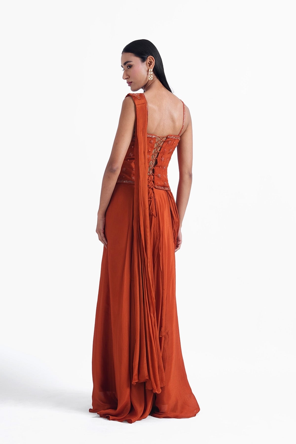 Rust orange palazzo saree paired with a long corset top
